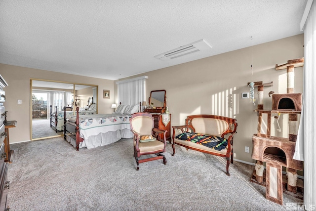 carpeted bedroom featuring access to exterior and a textured ceiling