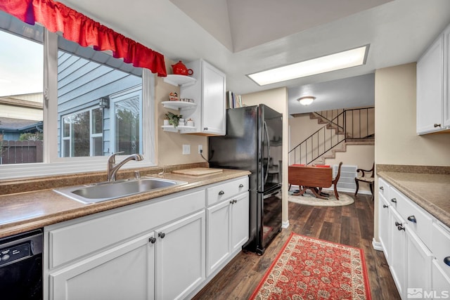 kitchen with white cabinetry, black appliances, and sink