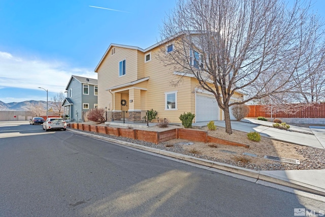 front facade with a mountain view and a garage