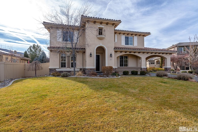 mediterranean / spanish home with covered porch and a front yard