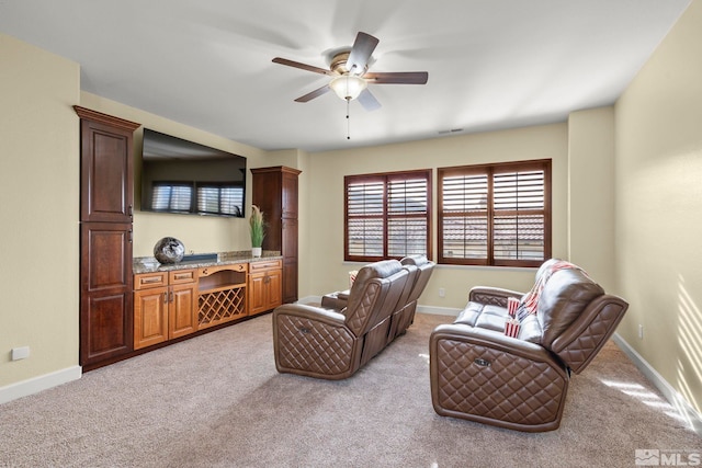 carpeted living room featuring ceiling fan