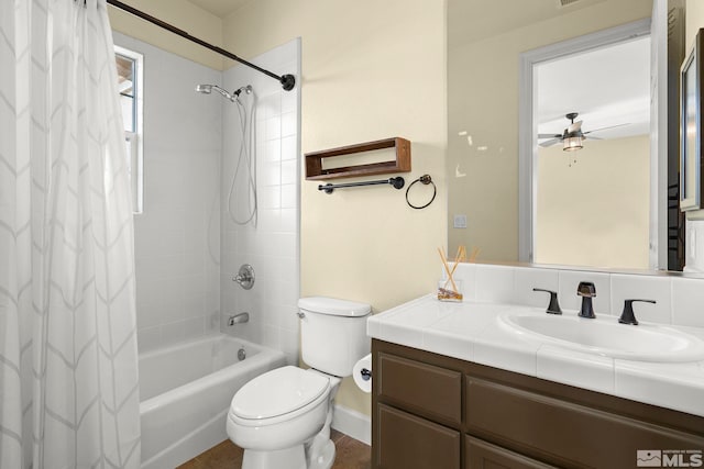 full bathroom featuring ceiling fan, vanity, shower / bath combination with curtain, and toilet