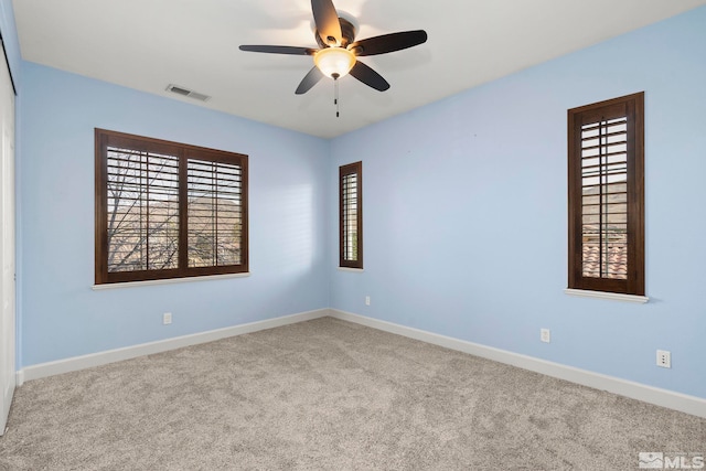 unfurnished room with light carpet and ceiling fan