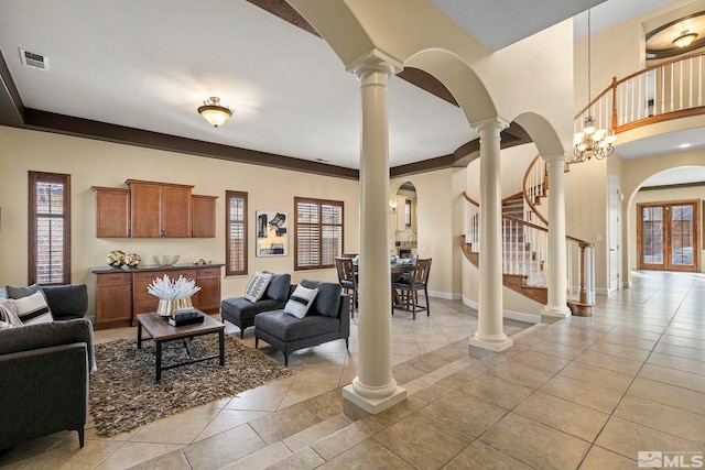 tiled living room featuring french doors and an inviting chandelier