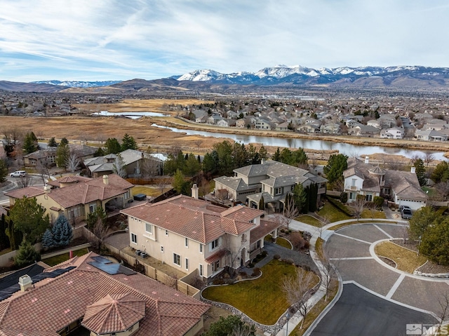 drone / aerial view with a water and mountain view