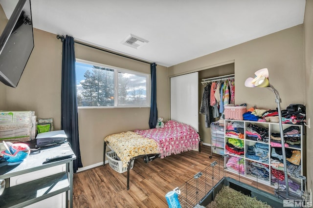 bedroom with hardwood / wood-style flooring and a closet