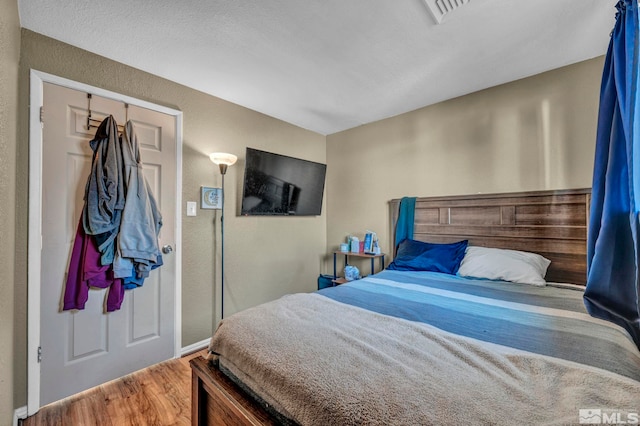 bedroom with a closet and wood-type flooring