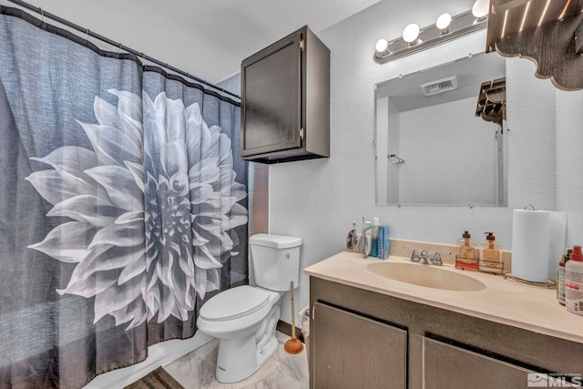 bathroom featuring vanity, toilet, and walk in shower