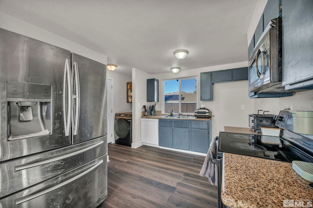 kitchen featuring sink, stainless steel fridge, a textured ceiling, dark hardwood / wood-style flooring, and washer / clothes dryer