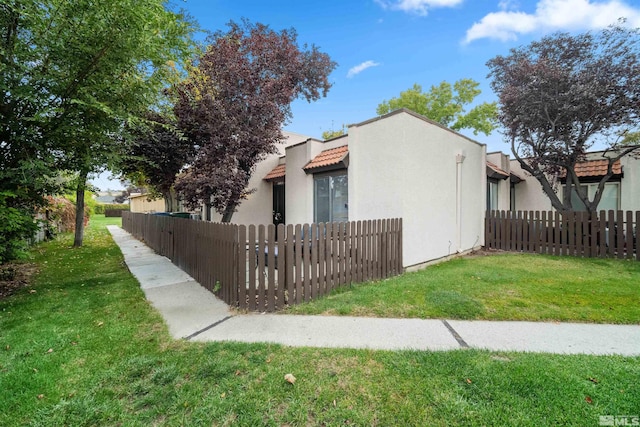 view of side of home with a lawn