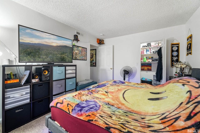 carpeted bedroom with a textured ceiling