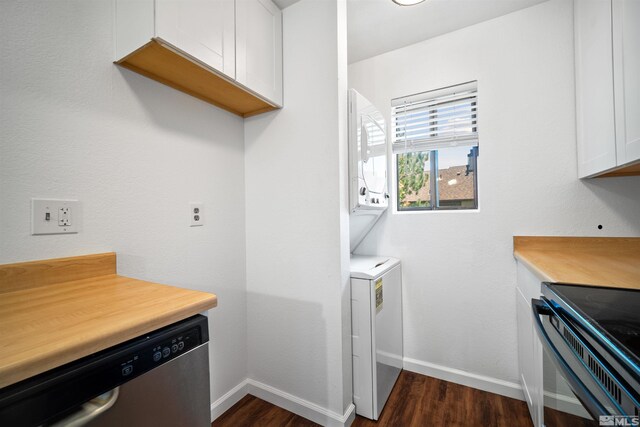 clothes washing area with dark hardwood / wood-style flooring and stacked washer and dryer