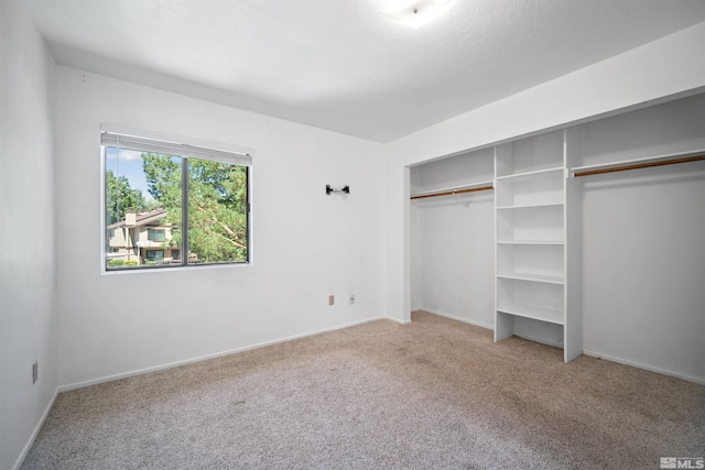 unfurnished bedroom with carpet and a closet