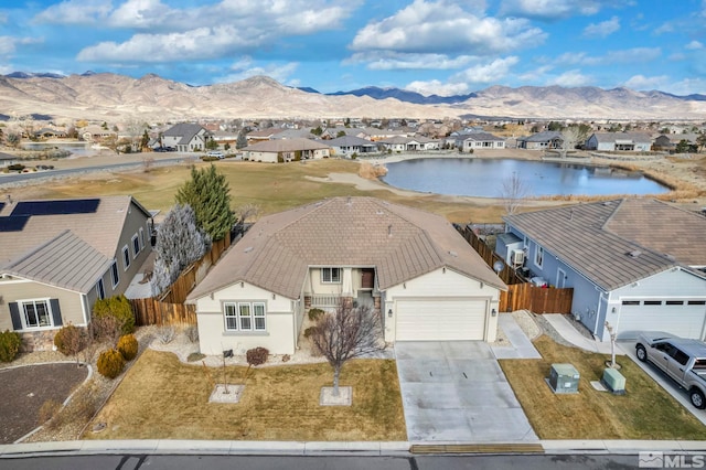 aerial view featuring a water and mountain view