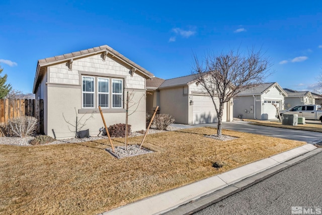 view of front of home with a front lawn and a garage