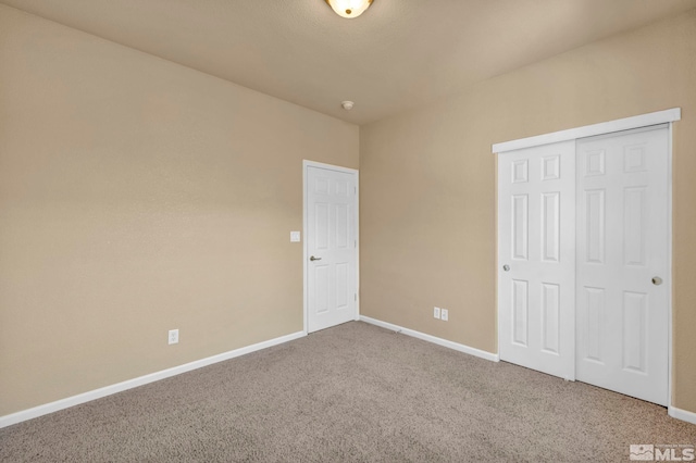 unfurnished bedroom featuring carpet flooring and a closet