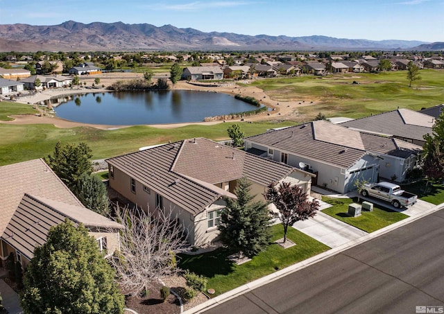 drone / aerial view with a water and mountain view