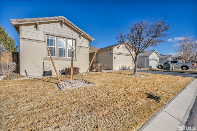 view of front of house with a front yard and a garage