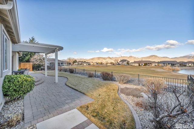 view of yard with a patio and a water and mountain view