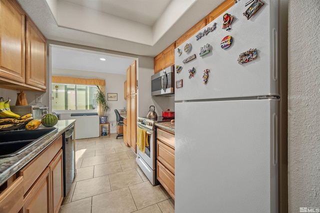 kitchen featuring light tile patterned flooring, sink, and appliances with stainless steel finishes