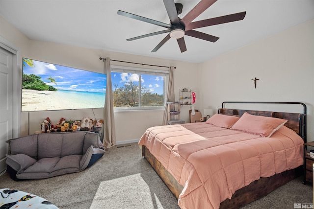 bedroom featuring ceiling fan and carpet