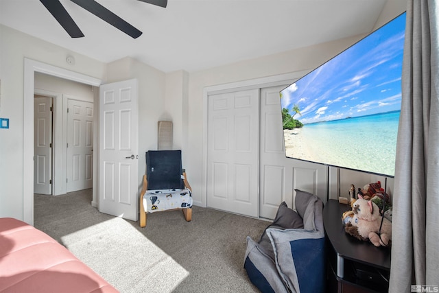 carpeted bedroom with ceiling fan and a closet