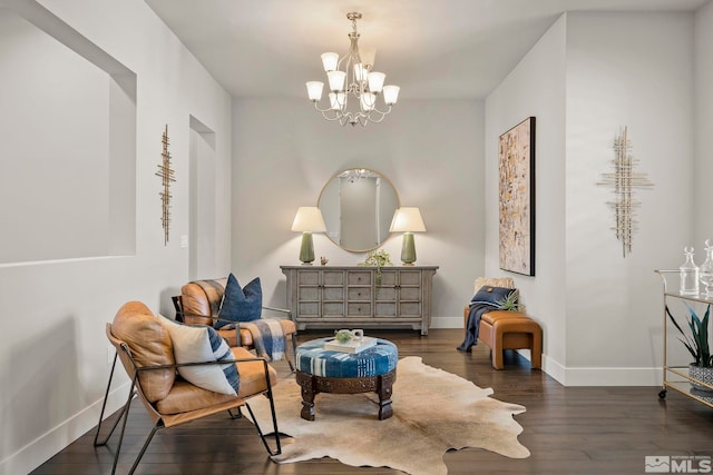 living area with dark hardwood / wood-style floors and a notable chandelier