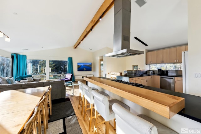 kitchen with sink, stainless steel appliances, lofted ceiling with beams, decorative backsplash, and exhaust hood