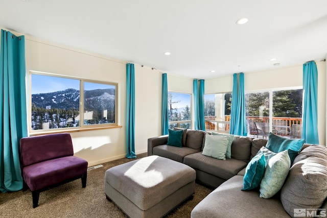 carpeted living room with a mountain view