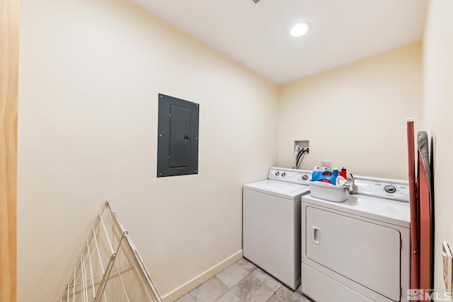 laundry room featuring electric panel and washer and clothes dryer