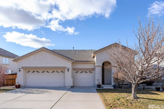 view of front of house with a front yard and a garage