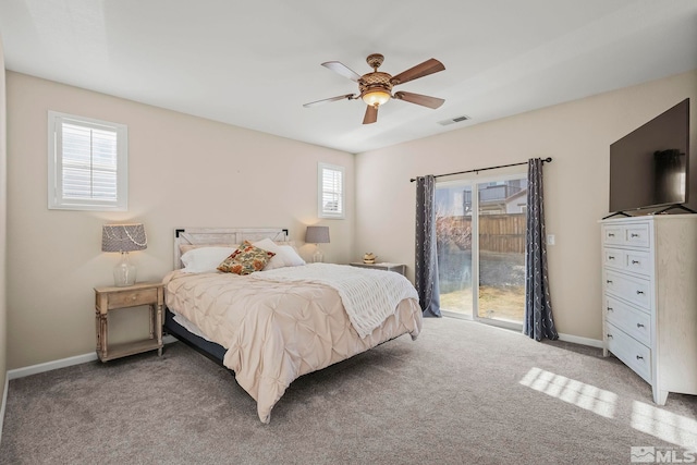 bedroom featuring ceiling fan, light carpet, access to outside, and multiple windows