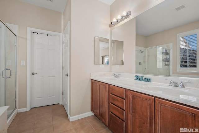 bathroom with tile patterned floors, vanity, and walk in shower