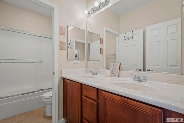 full bathroom featuring tile patterned flooring, toilet, combined bath / shower with glass door, and vanity