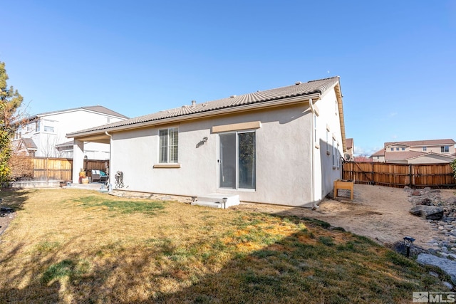 rear view of house with a lawn