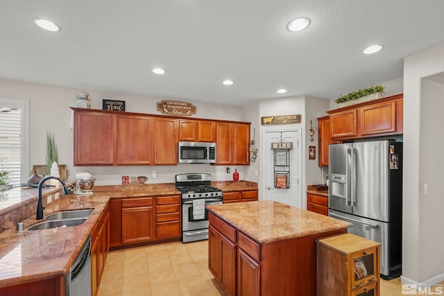 kitchen with sink, a kitchen island, light stone counters, kitchen peninsula, and stainless steel appliances