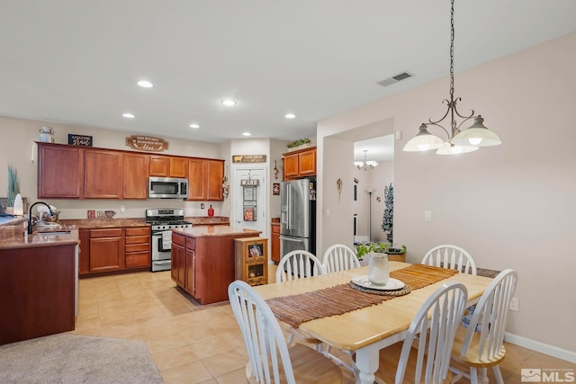 tiled dining area with a notable chandelier and sink