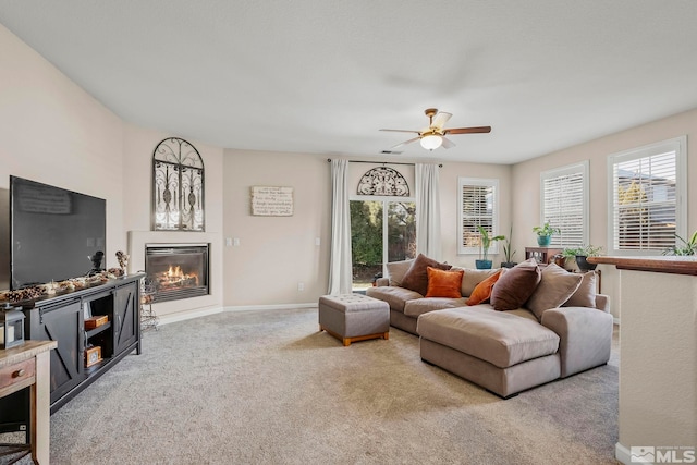 carpeted living room with ceiling fan and a wealth of natural light