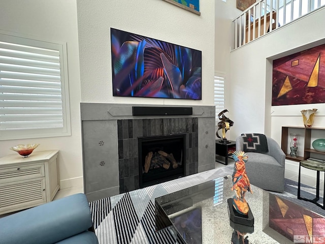 living room featuring a tile fireplace