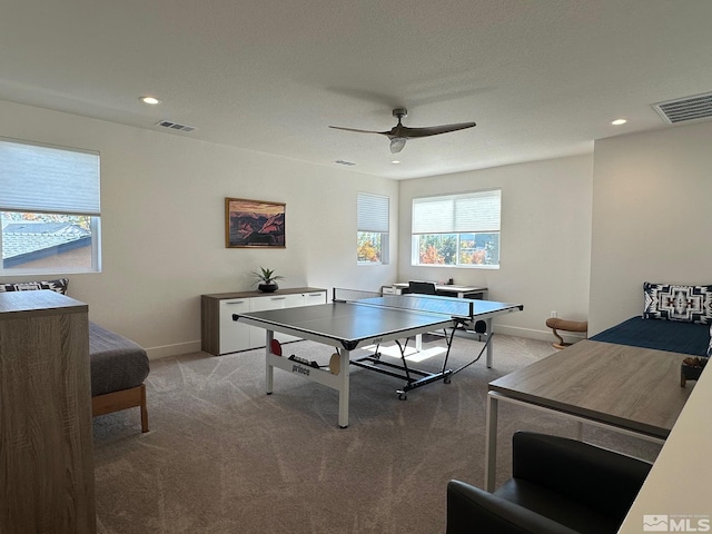 game room with light carpet and ceiling fan