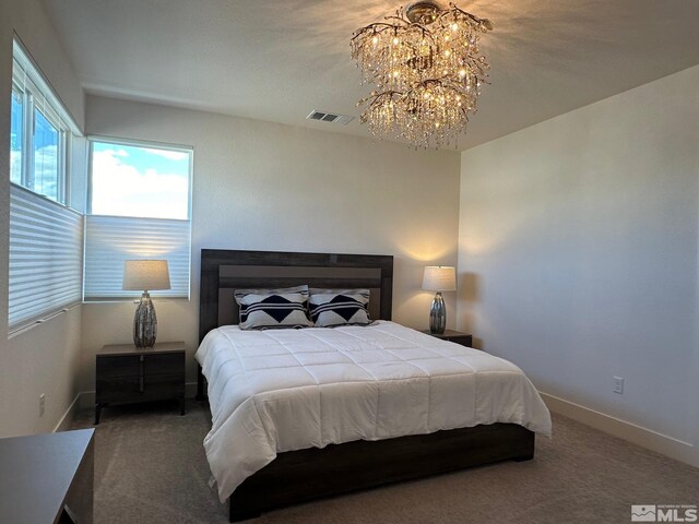 bedroom featuring carpet and a chandelier