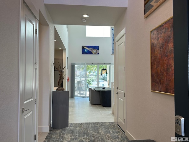 hall with light tile patterned floors