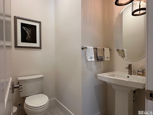 bathroom with tile patterned floors and toilet