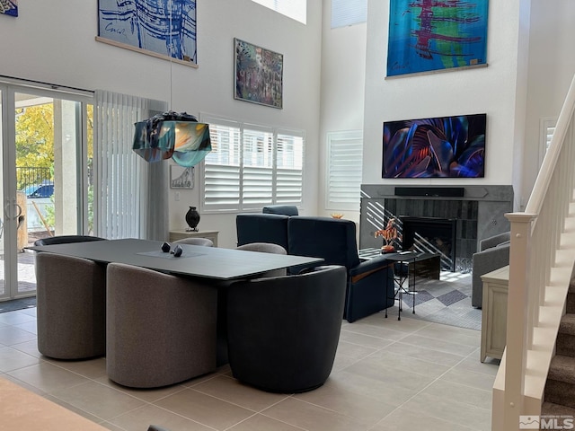 tiled office featuring a high ceiling and a tile fireplace