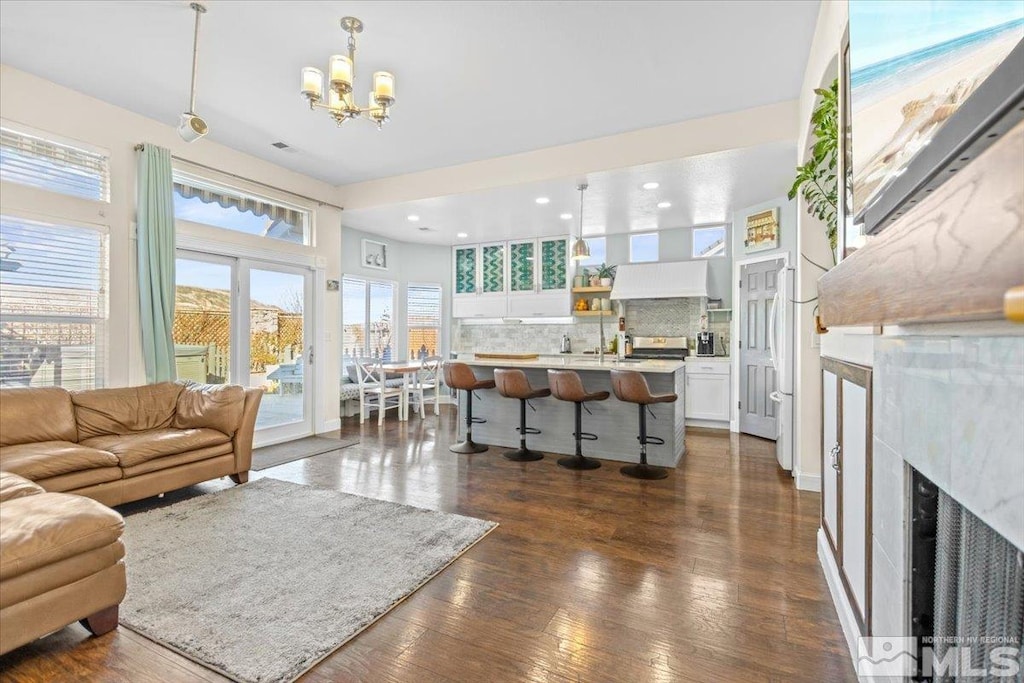 living room with dark hardwood / wood-style floors and a notable chandelier