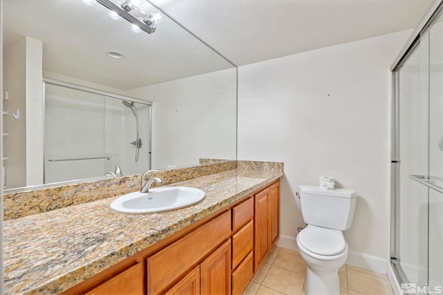 bathroom featuring walk in shower, tile patterned flooring, vanity, and toilet