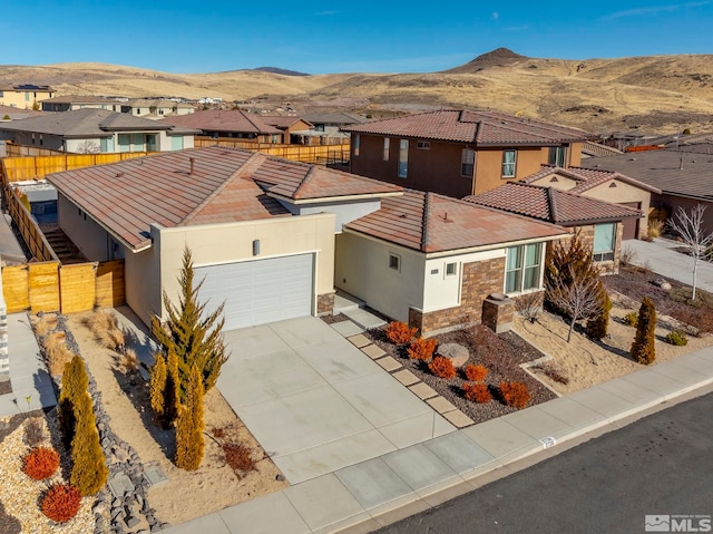 view of front of property featuring a mountain view and a garage