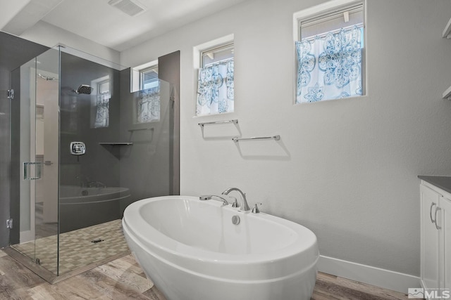 bathroom featuring vanity, independent shower and bath, and hardwood / wood-style flooring