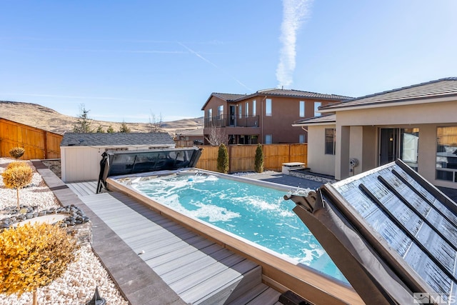 view of swimming pool with a storage shed