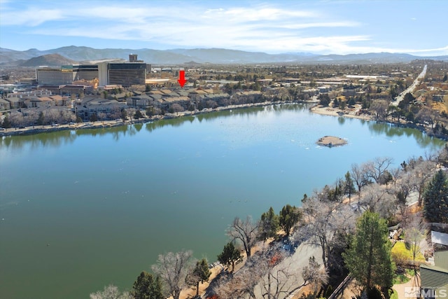 drone / aerial view featuring a water and mountain view